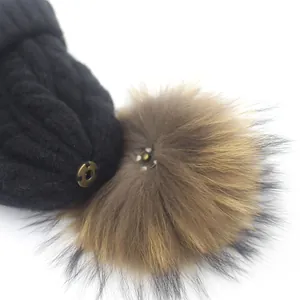 Black knit beanie with real raccoon fur pom-pom and detachable metal snap button closure