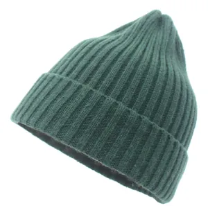 Close-up of deep green ribbed knit beanie showing wool texture and thick folded cuff