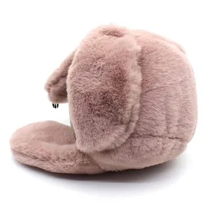 Detailed side view of soft faux rabbit fur earflap hat in a plush pink finish