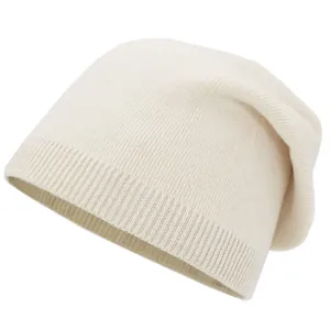 Detail shot of the ribbed knit texture and soft off-white fabric of the beanie