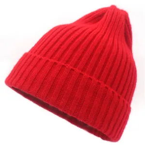 Detailed view of the red ribbed knit texture and wide folded cuff on this warm winter hat