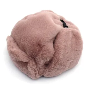 Detail view of pink faux fur winter hat featuring a side buckle for ear protection