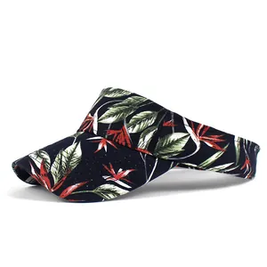 Side view of a floral print sun visor hat with tropical leaf patterns on dark blue canvas