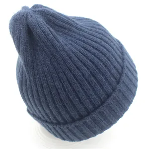 Close-up of dark blue ribbed knit beanie showing high-quality wool texture for winter