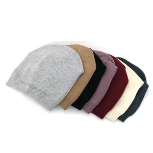 Women's warm knitted beanie hats in multiple colors with ribbed cuffs on white background