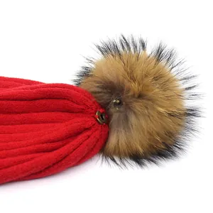 Red knit rabbit fur beanie with large real raccoon fur pom-pom and metal snap button