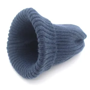 Detail of navy blue ribbed knit texture and wool blend fabric on warm winter beanie