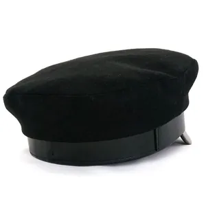 Detail of black wool flat top military hat featuring a faux leather strap and visor