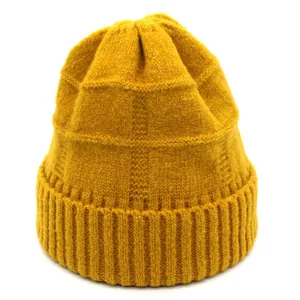 Detailed texture of ginger knit beanie with ribbing and square pattern surface