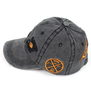 Detail showing vintage washed cotton fabric and precise eye embroidery on baseball cap