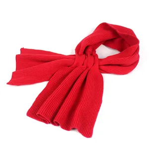 Detail view of deep red knitted scarf featuring vertical ribbed texture and soft fabric fold