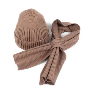 Detail of brown ribbed knit beanie and matching scarf set with vertical texture