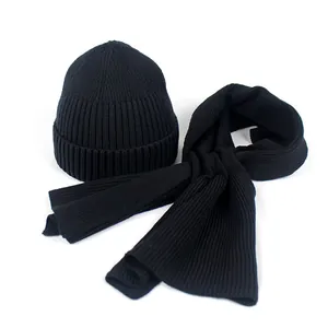 Close-up of black ribbed knit winter set featuring a warm beanie and matching scarf