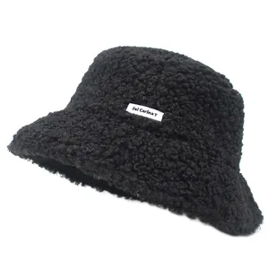 Close-up of the soft black teddy faux fur bucket hat with white Sei Carina Y letter label