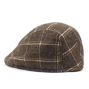 Detail of vintage brown plaid newsboy cap showing wool texture and check pattern