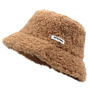 Detail shot of khaki teddy fleece bucket hat featuring soft texture and woven label