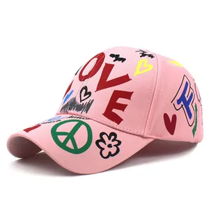 Berretto da baseball in cotone rosa con graffiti colorati e scritta LOVE su sfondo bianco
