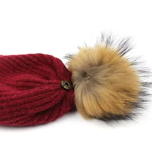 Women's burgundy wool knit beanie with removable natural raccoon fur pompom