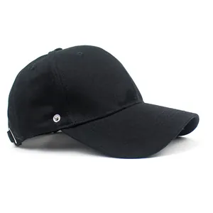 Close-up of black cotton baseball cap showing side metal buckle and twill fabric texture