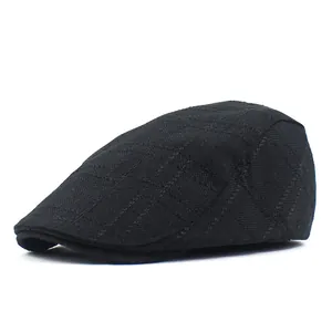 Detail of classic black ivy cap featuring a textured diamond grid pattern on fabric