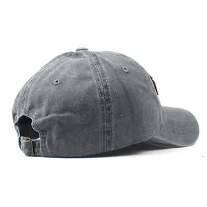 Detail of adjustable metal buckle and vintage washed gray cotton fabric on baseball cap