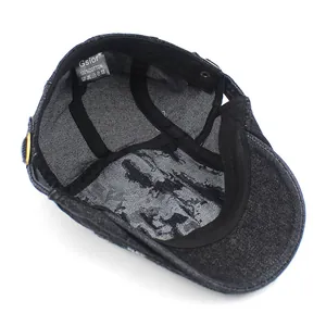 Detail of 100% cotton washed denim beret with brand label and internal stitching