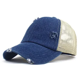 Detail of distressed navy denim baseball cap with beige mesh and worn-out texture