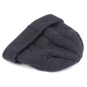 Close-up of the knitted texture and folded brim on a dark gray winter beanie cap