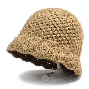 Chic khaki knitted bucket hat with a stylish wavy brim displayed on a white background