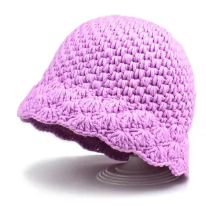 Women's lavender knit bucket hat with warm crochet texture and scalloped petal brim edge