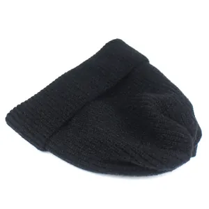 Detail of the black vertical ribbed knit texture on a cozy winter beanie hat