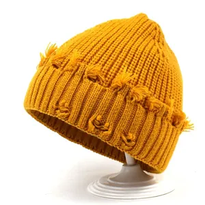 Ginger yellow knitted beanie with distressed fringe detailing and thick ribbed texture