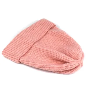 Detail of pink ribbed knit beanie featuring thick texture and winter fold-over cuff design