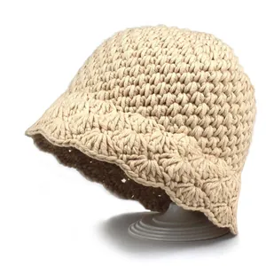 Detailed knit texture of beige crochet bucket hat with vintage wavy brim on stand