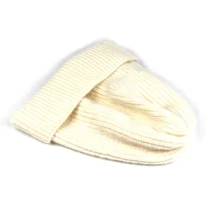 Detailed view of cream rib-knit winter beanie with thick wool texture and folded cuff