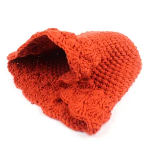 Close-up of thick crochet texture and wavy edge on this orange knit bucket hat