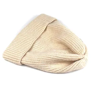 Close-up of the vertical ribbed knit texture and wide folded cuff on this beige winter beanie