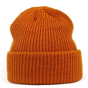 Detailed view of ginger orange ribbed knit beanie with wide cuffed hem for winter