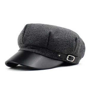 Detail of wool blend octagonal newsboy hat with black faux leather brim and metal buckle