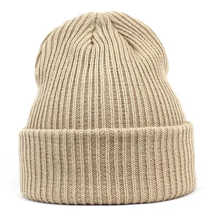 Detailed view of the ribbed knit texture and wide cuff on a beige winter beanie hat