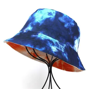 Detail view of colorful tie-dye bucket hat with blue and orange reversible canvas fabric