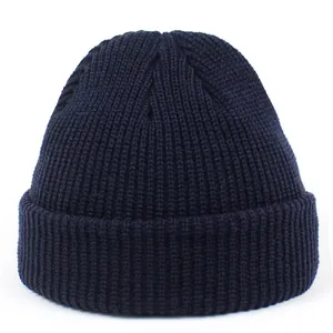Detailed view of navy blue ribbed knit texture and wide folded brim on skull cap