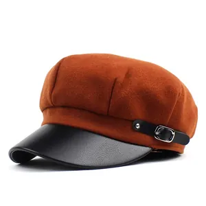 Detail of wool octagonal newsboy hat with caramel fabric and black leather visor