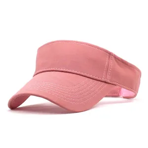 Detail of pink sport sun visor with white reinforced stitching and breathable fabric texture
