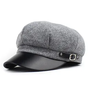 Detail of grey wool octagonal hat with black leather brim and silver metal buckle