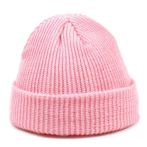 Detailed view of pink rib-knit beanie showing the thick acrylic fiber texture and fold-over cuff