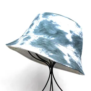 Women's reversible tie-dye bucket hat with blue and white pattern on metal stand
