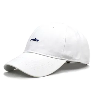 Detailed embroidery of a small blue whale on a white cotton twill baseball cap