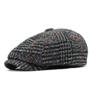 Close-up of grey and black plaid newsboy cap showing wool blend fabric texture