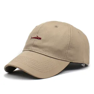 Close-up of red whale embroidery on a khaki cotton baseball cap with neat stitching